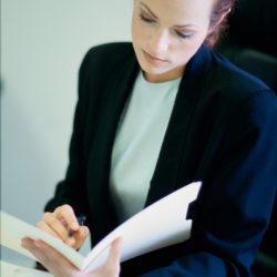 Businesswoman seated behind a desk in an office
