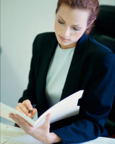 Businesswoman seated behind a desk in an office