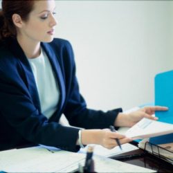 Businesswoman seated behind a desk in an office